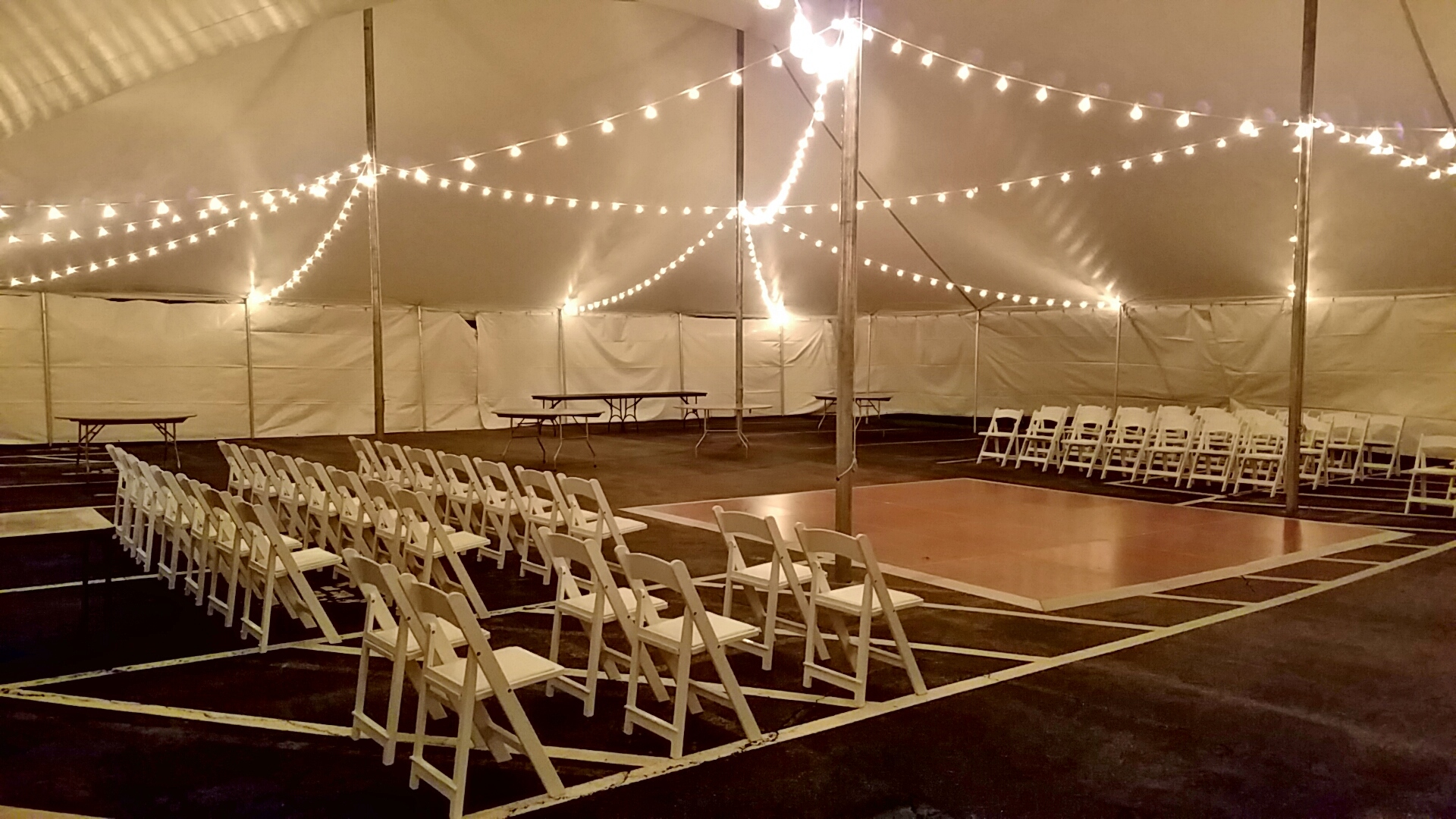 White padded garden chairs, dance floor and cafe lighting for rent in Chester, PA