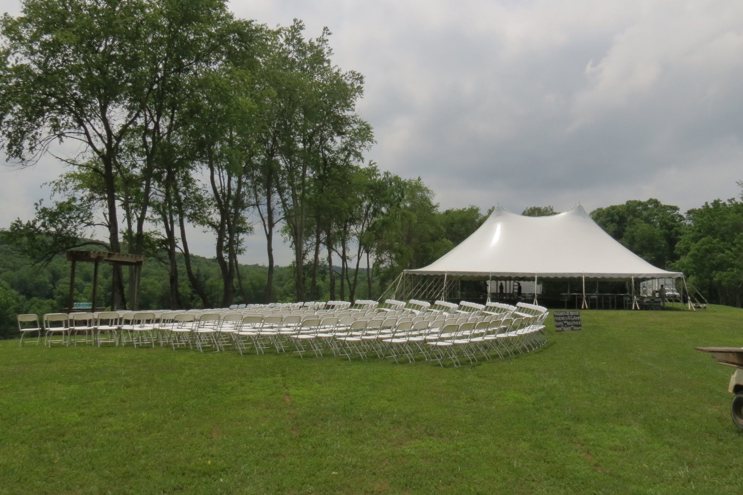 White folding chairs and white pole tents for rent in Chambersburg, PA