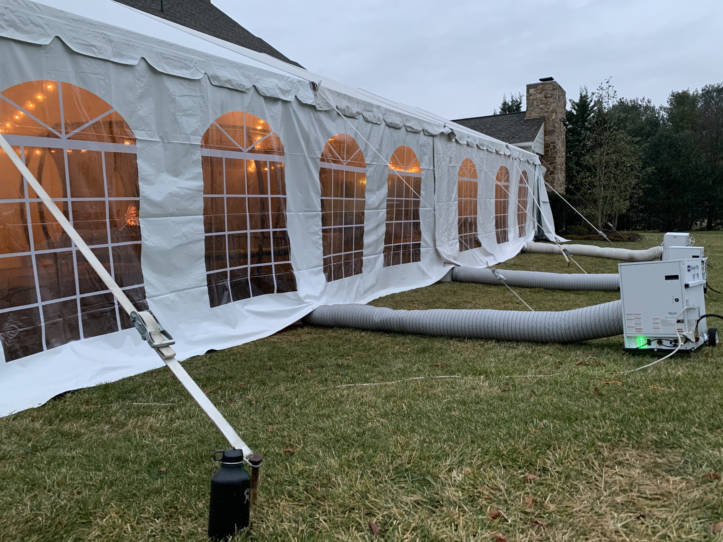 Quiet heaters sit outside the tent and blow heat in