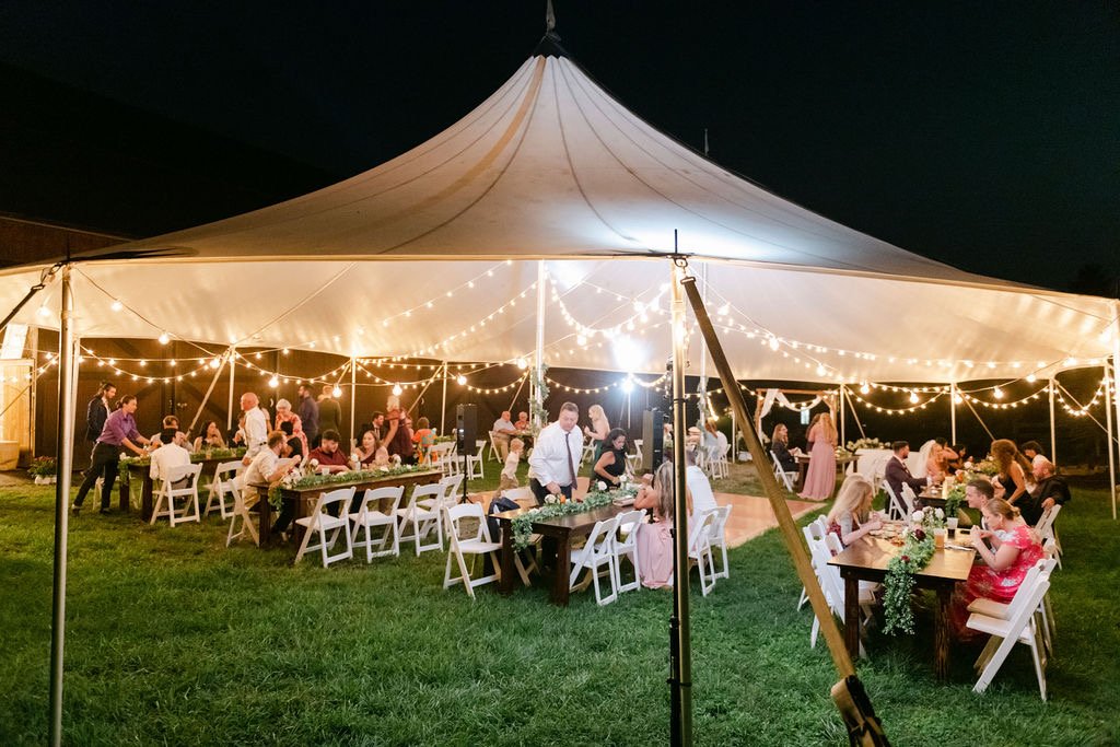 45x64 sailcloth wedding tent at night with cafe lights