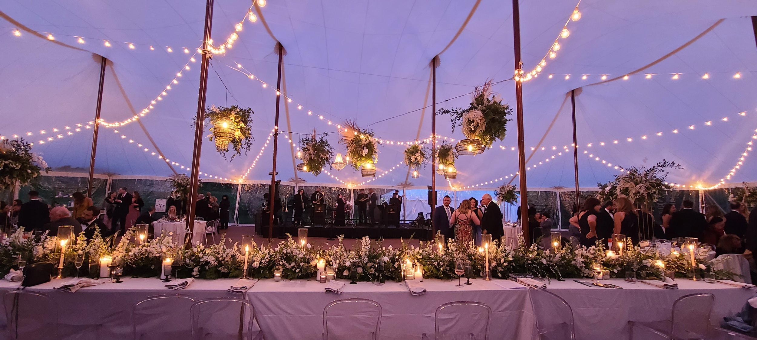 59x98  sailcloth wedding tent with faux wooden poles and cafe lights