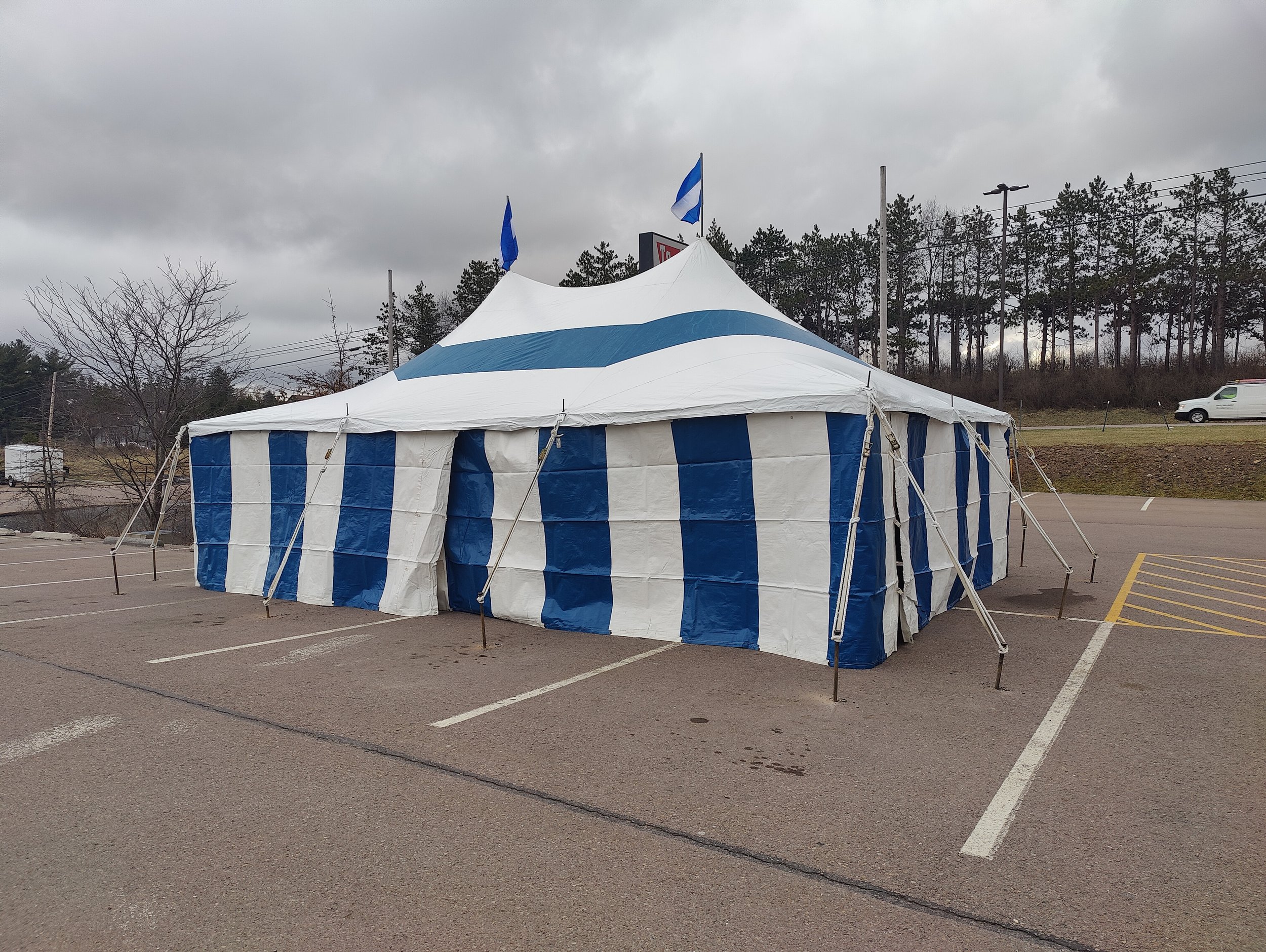 20x30 blue and white striped colored tent on asphalt