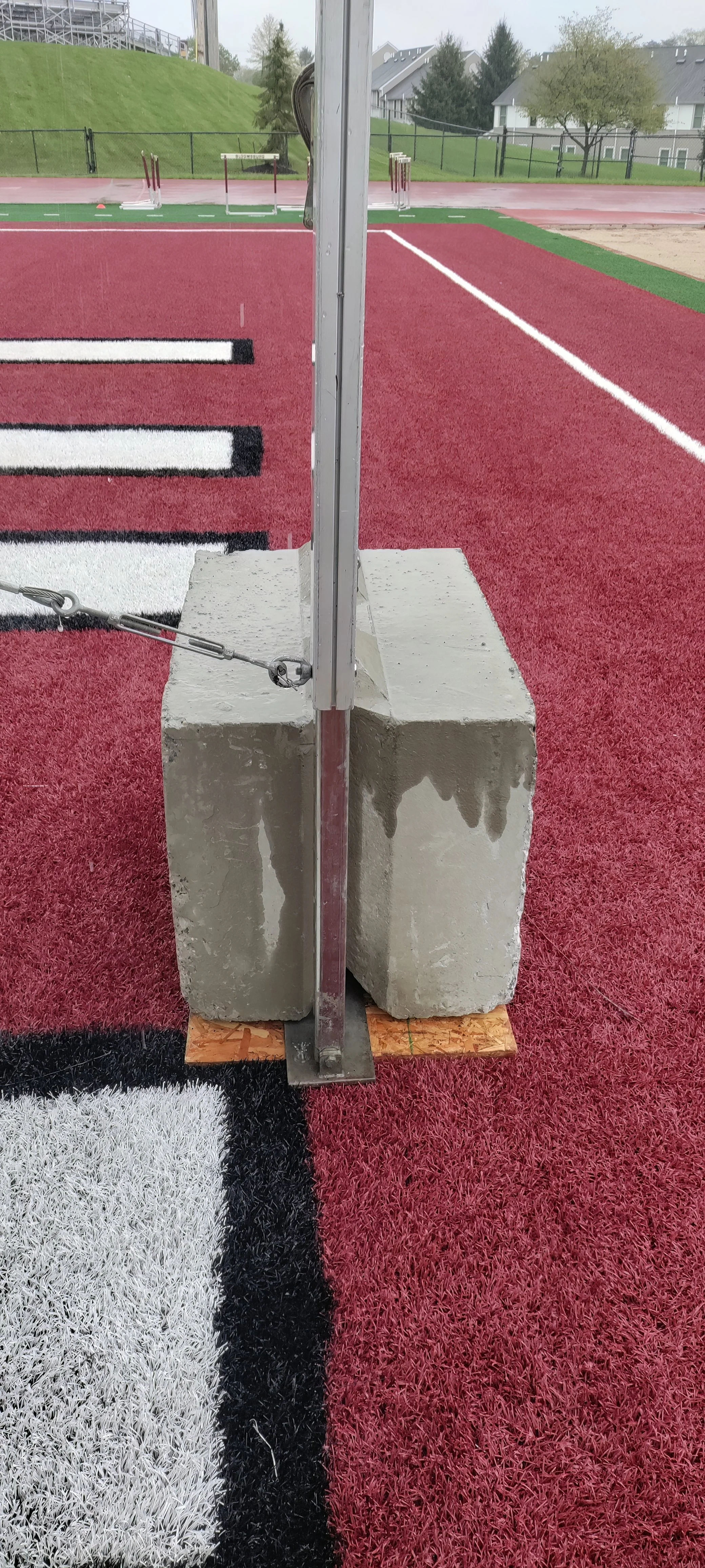 1,600 lb. concrete weights for securing a tent on turf football field