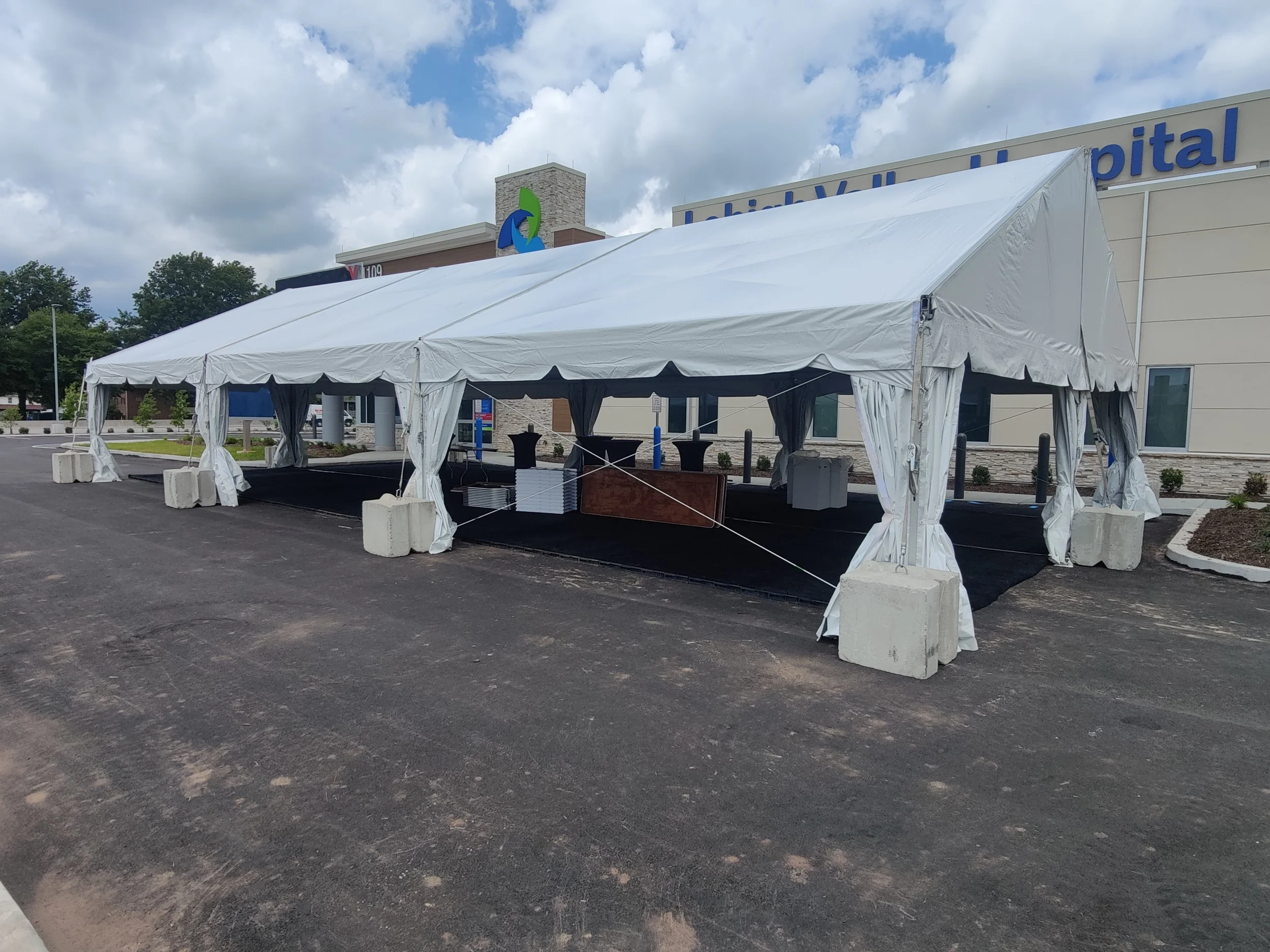 Tents For Rent frame tent secured with concrete block weights