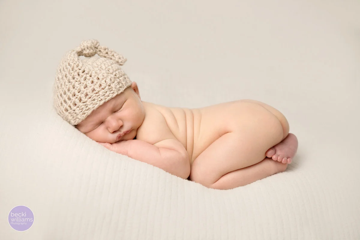 Newborn photos - On Tummy - cream hat - posed