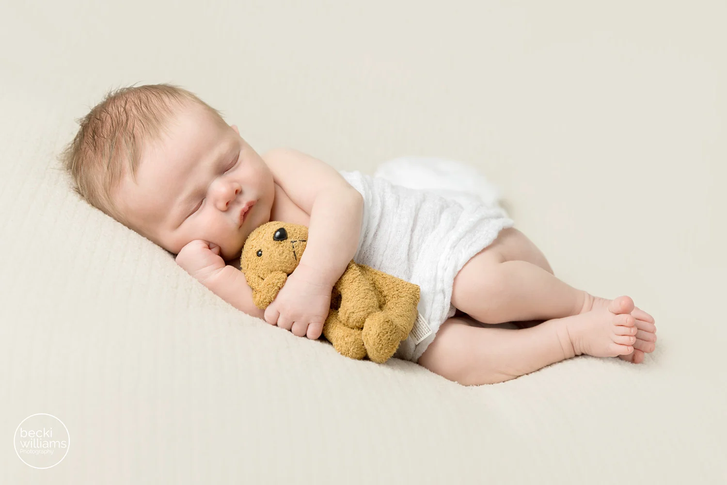 Newborn pictures hemel hempstead - asleep newborn boy cuddles his teddy