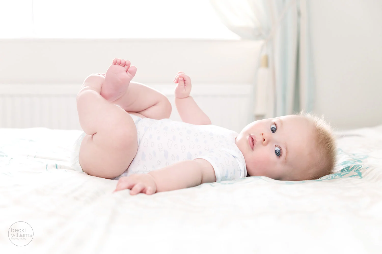 baby pictures - 6 month old photography - laying on bed