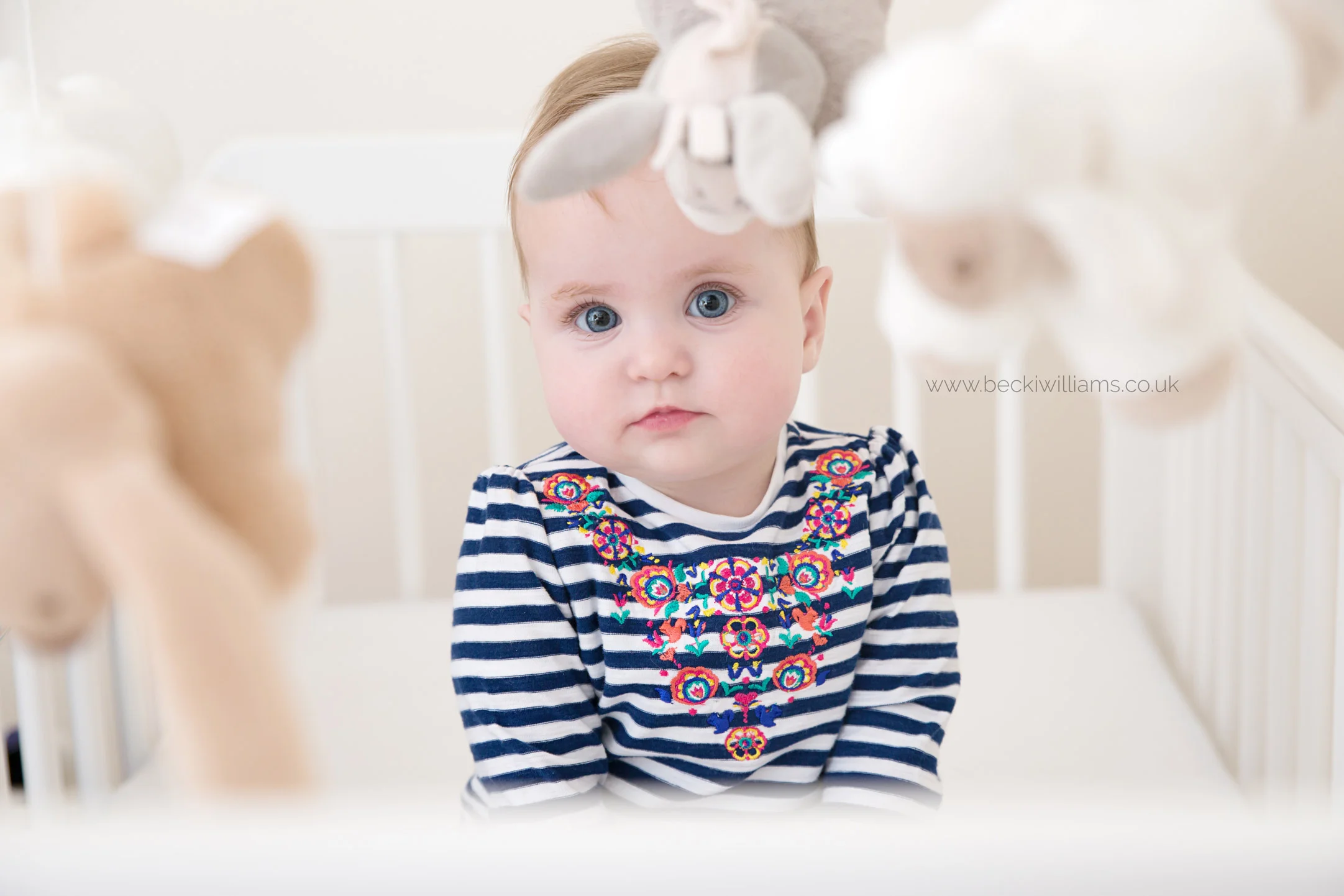 Baby-photography-hemel-hempstead-baby-in-cot-through-mobile