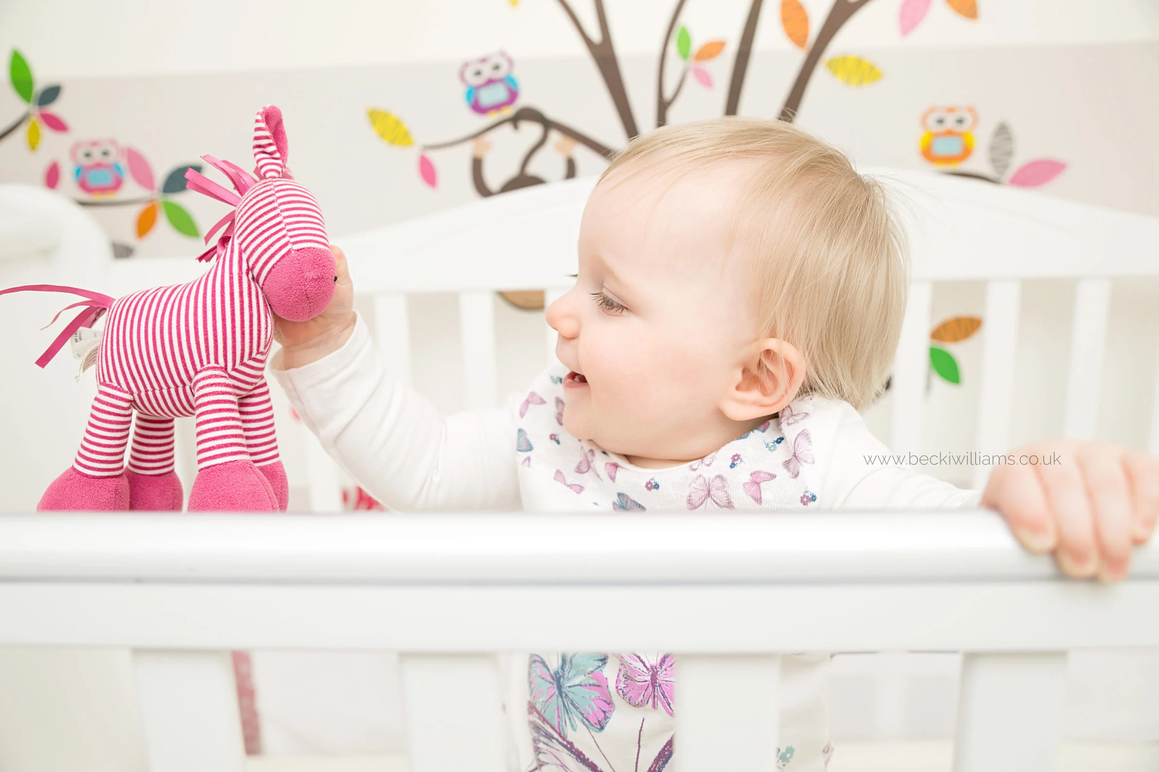 baby-photography-hemel-hempstead-playing-in-cot-at-home-relaxed