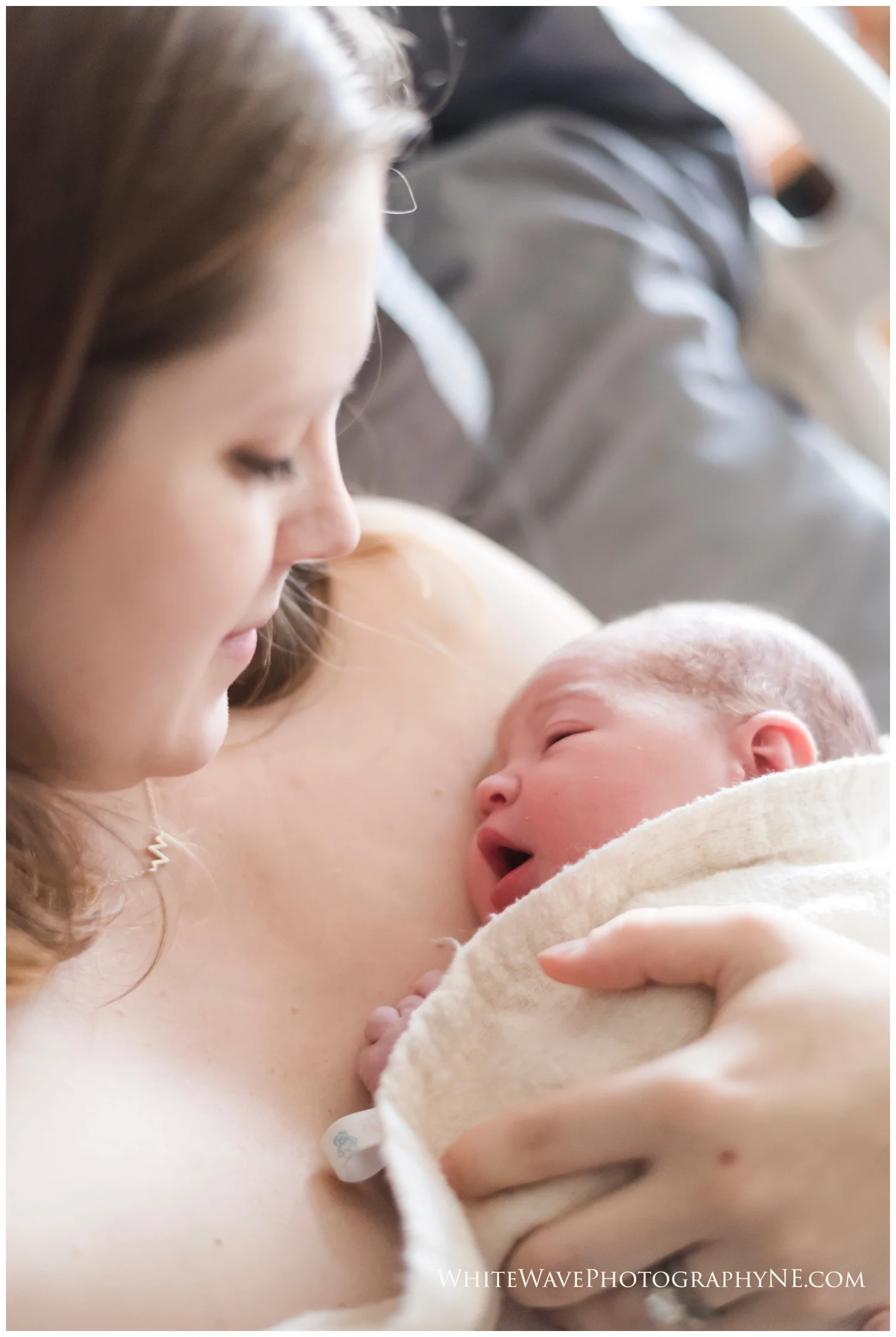 new mum holding her brand new baby in her hospital bed
