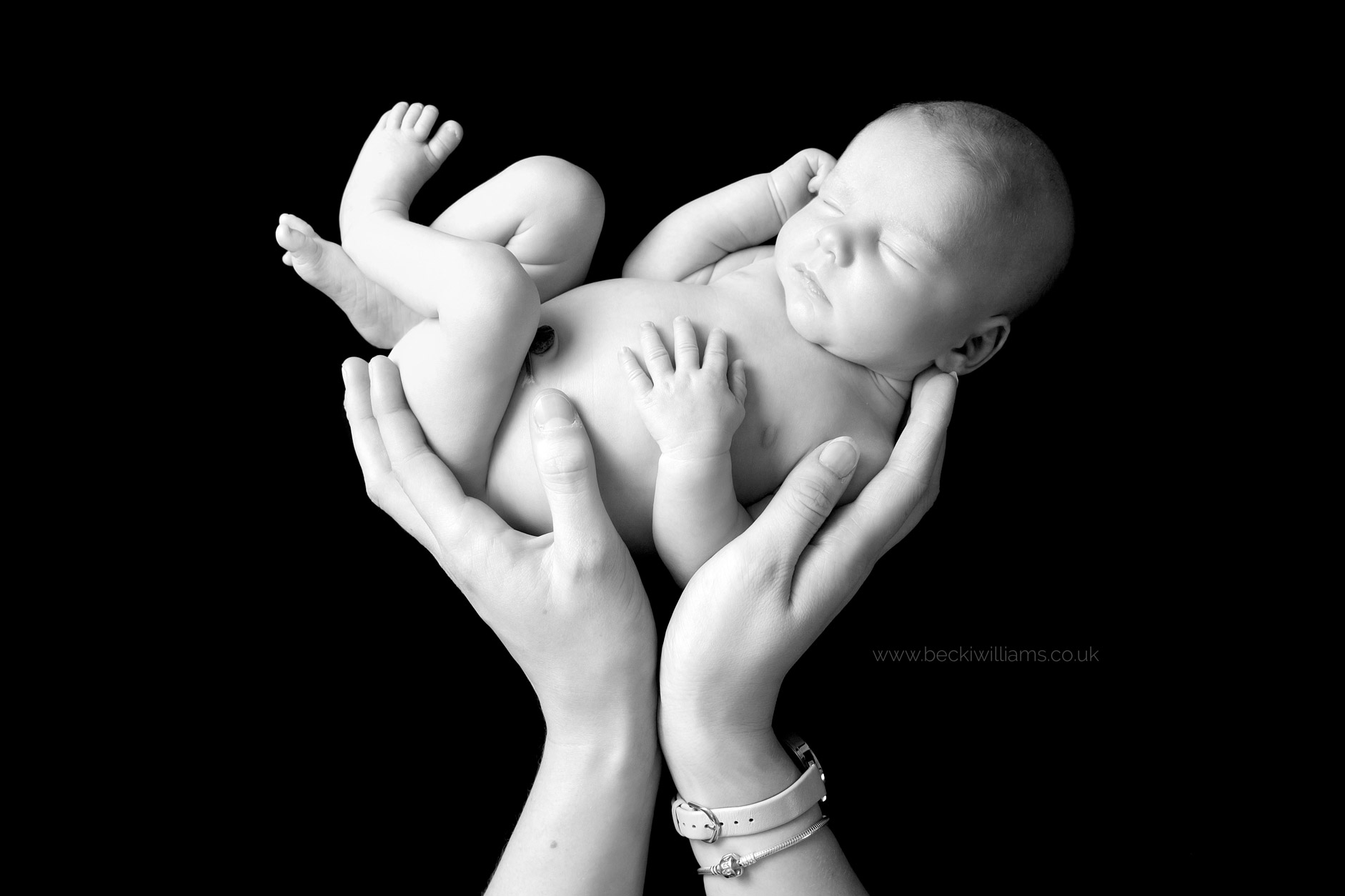 newborn-photography-hemel-hempstead-baby-in-parents-hands.jpg