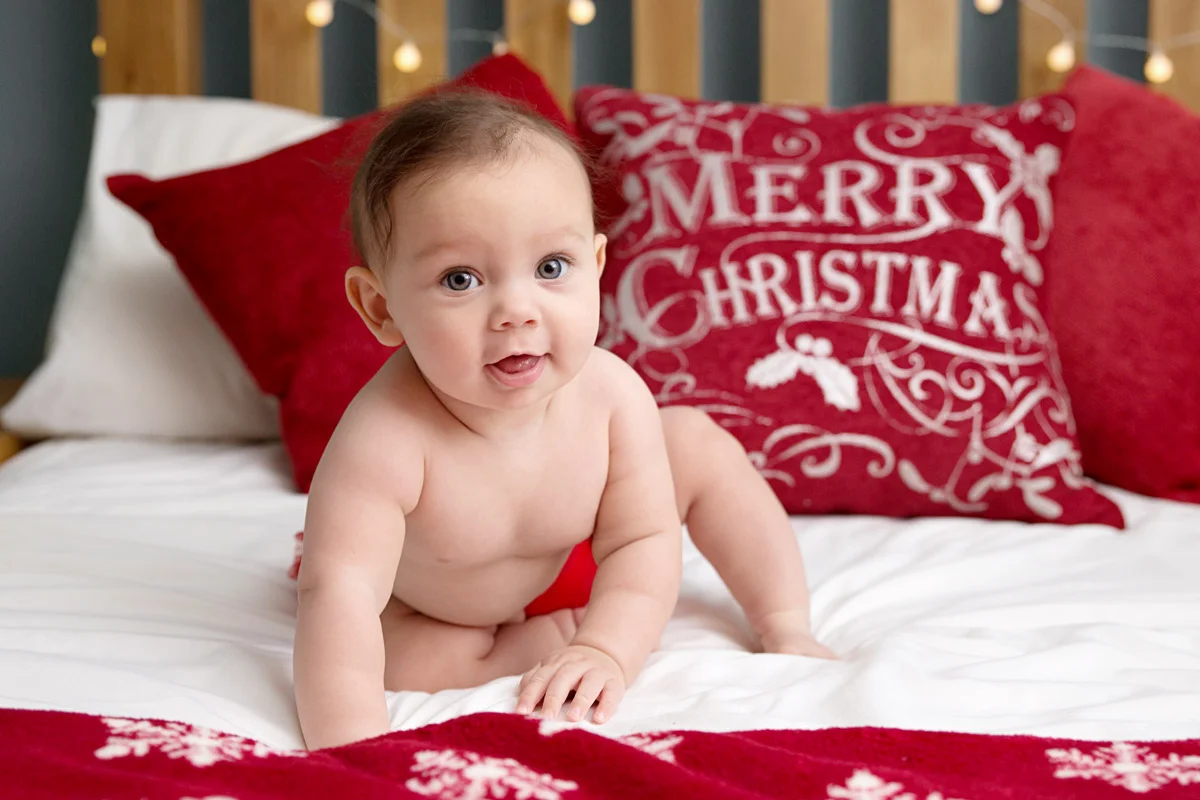 christmas baby photo on a big bed