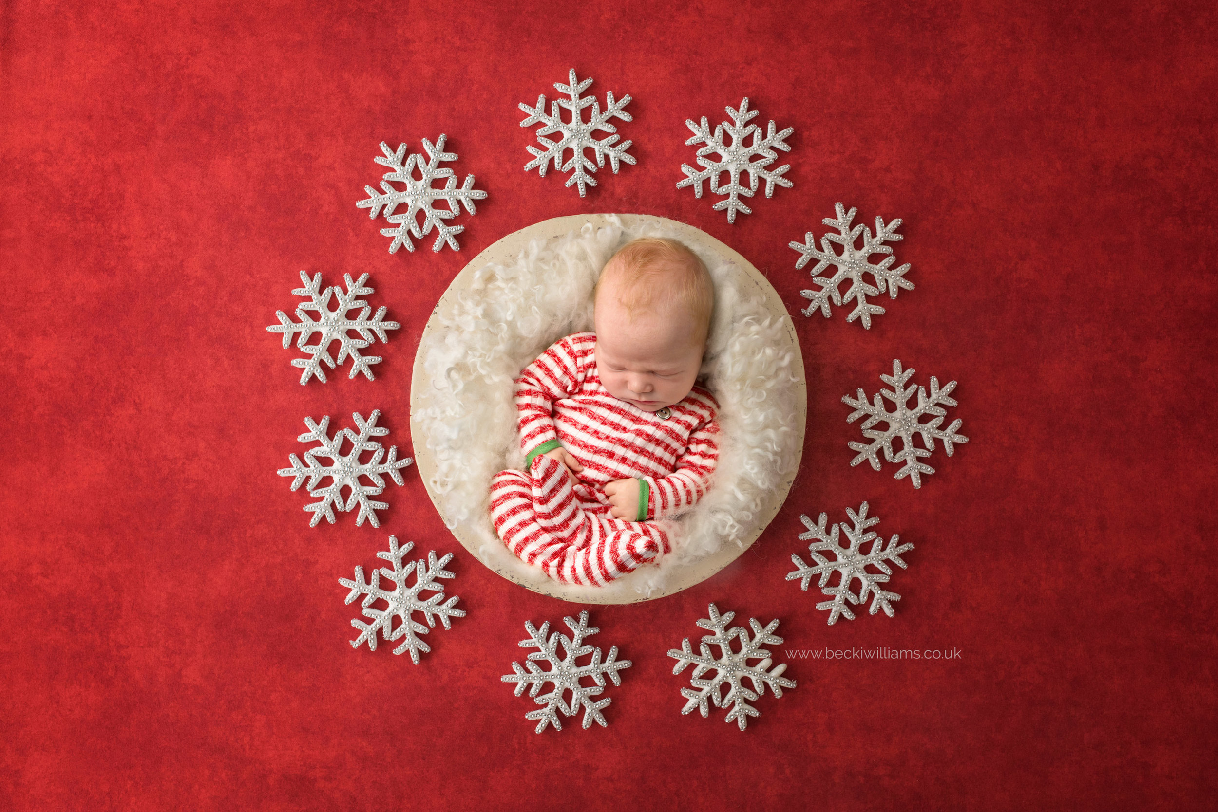 newborn-boy-portraits-hemel-hempstead-christmas-digital-background-red-snow.jpg