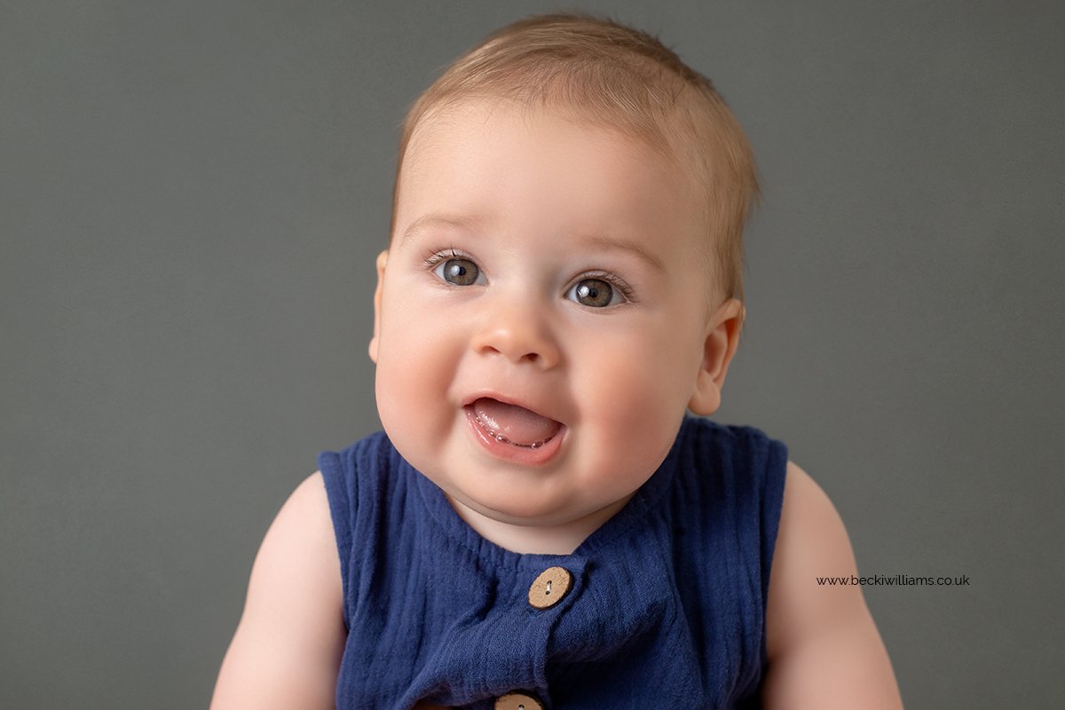 6 month old baby boy smiling, at his baby photo shoot in Milton Keynes