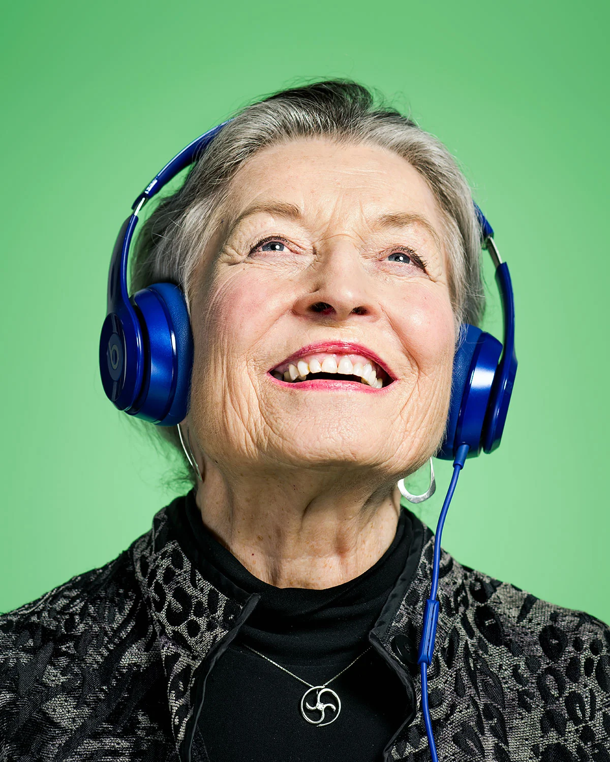 Judy Erdman, listening and singing to show tunes from a project matching Alzheimer's patients with music from their past. ↖︎ Commissions