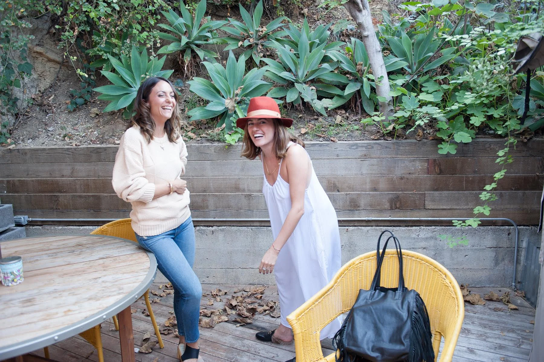 On Laura sweater by CALLAHAN , MOTHERDENIM jeans, shoes by NINA Z . On Juliet, TYSA jumper, LOVELY BIRD hat and GUCCI loafers. Fringe bag by HARTFORDPARISIAN . Image by Lauri Levenfeld.
