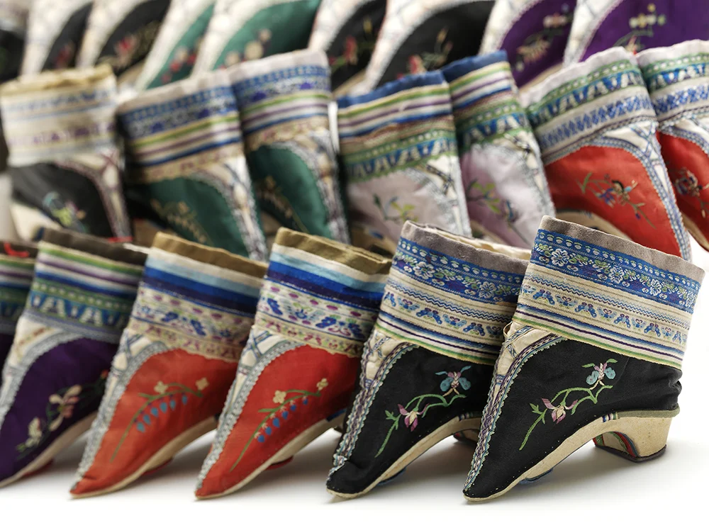 Pairs of shoes for bound feet Embroidered silk and cotton over wood China, late 1800s V&A: FE.89, 96, 87, 93, 97, 92, 90:1+2—2002. © Victoria and Albert Museum, London