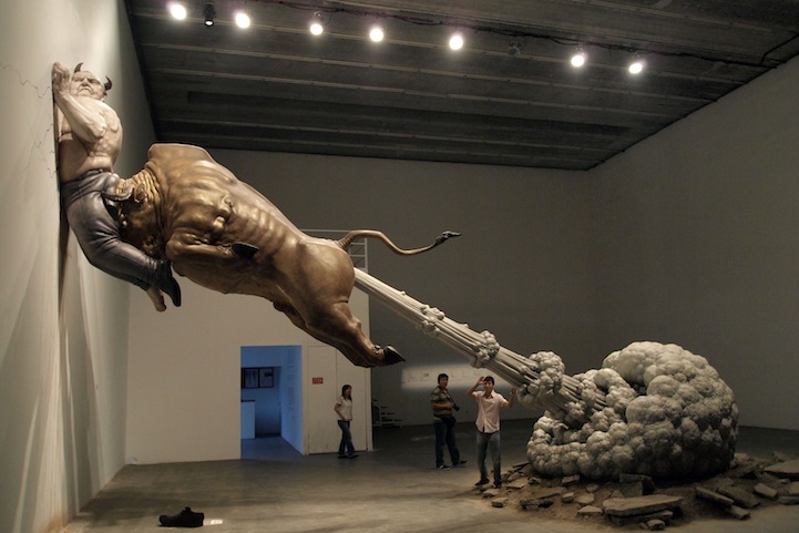 Chen Wenling's sculpture shows a bull, meant to represent Wall Street, seen ramming the biggest con man of all time, Bernie Madoff, into a wall. The huge cloud coming out of the bull's rear not only refers to the end of a greedy era, but also symbolizes the danger of virtual bubbles in international financial markets.