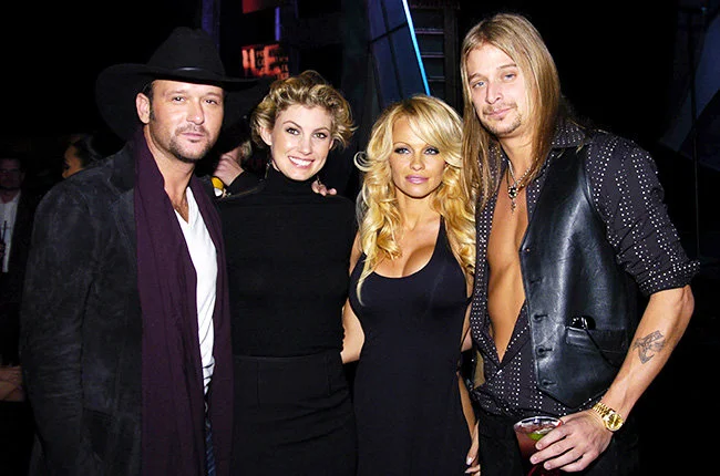 Tim, Faith, Pam and Kid Rock in 2003 Tim McGraw, Faith Hill, Pamela Anderson and Kid Rock grinned backstage at the 2003 AMAs.