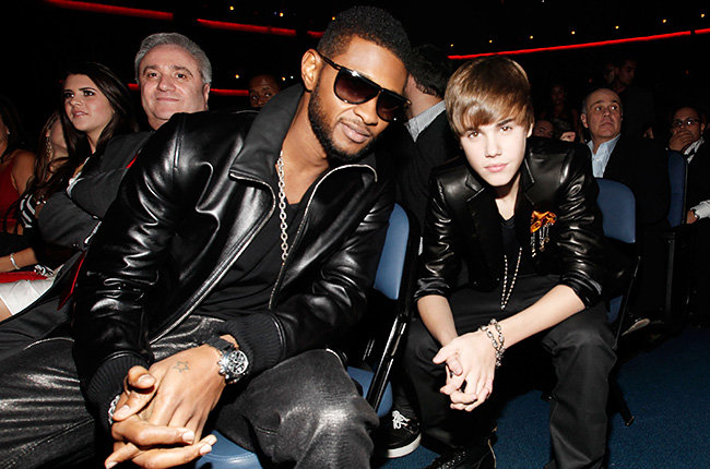 Usher and His Protege in 2010 Usher and Justin Bieber sat in the audience in matching black jackets at the 2010 AMAs.