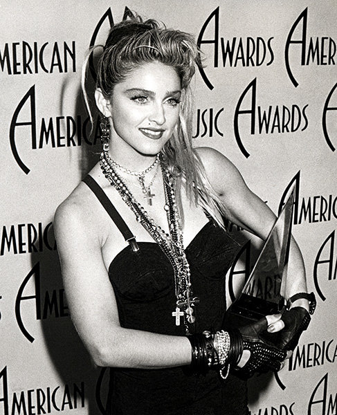 Madonna in 1985 Madonna cradles her award at the 1985 AMAs.