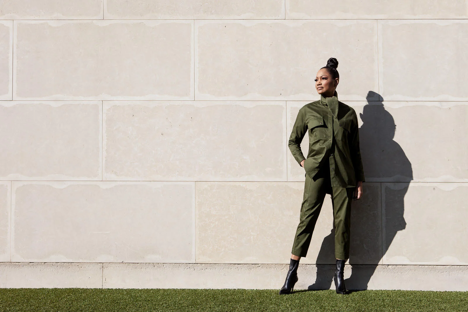 On Garcelle suit by Mango . Boots by Gucci. Sunglasses: Saint Laurent.