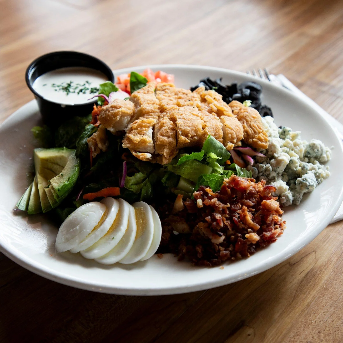 Midweek health kick&hellip; kinda. 

Crispy chicken, fresh avocado, eggs, olives, bacon, bleu cheese crumbles, tomatoes, and your choice of dressing.

It&rsquo;s basically health in a bowl.