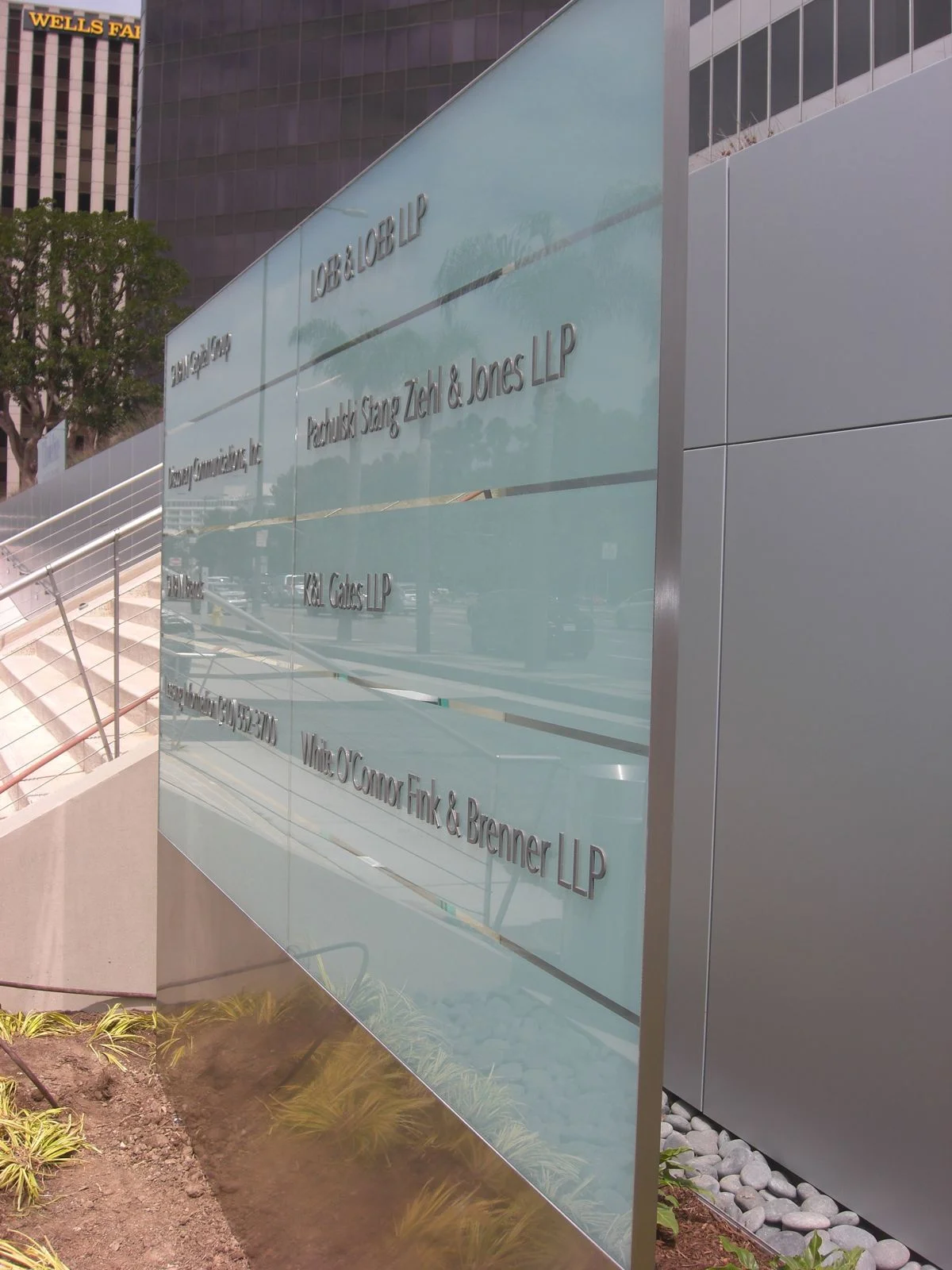  Laser-cut aluminum tenant names with painted finish, applied to glass surface. &nbsp; 