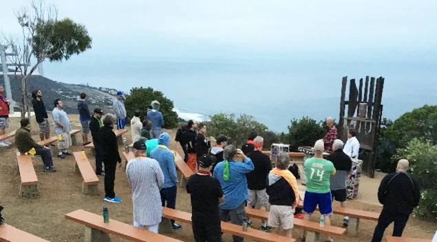 As the Sun rises in the East, calling in the four directions Sunrise ceremony at the Point.