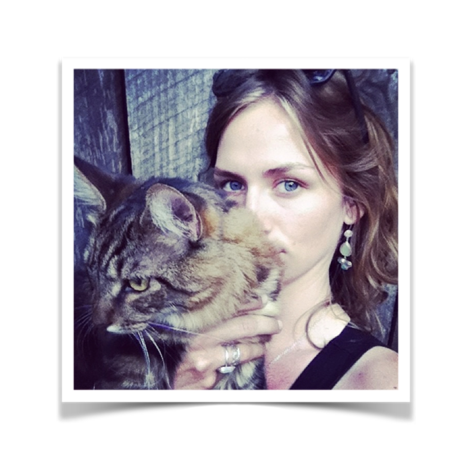 My earrings and my kitten in front of the shed.