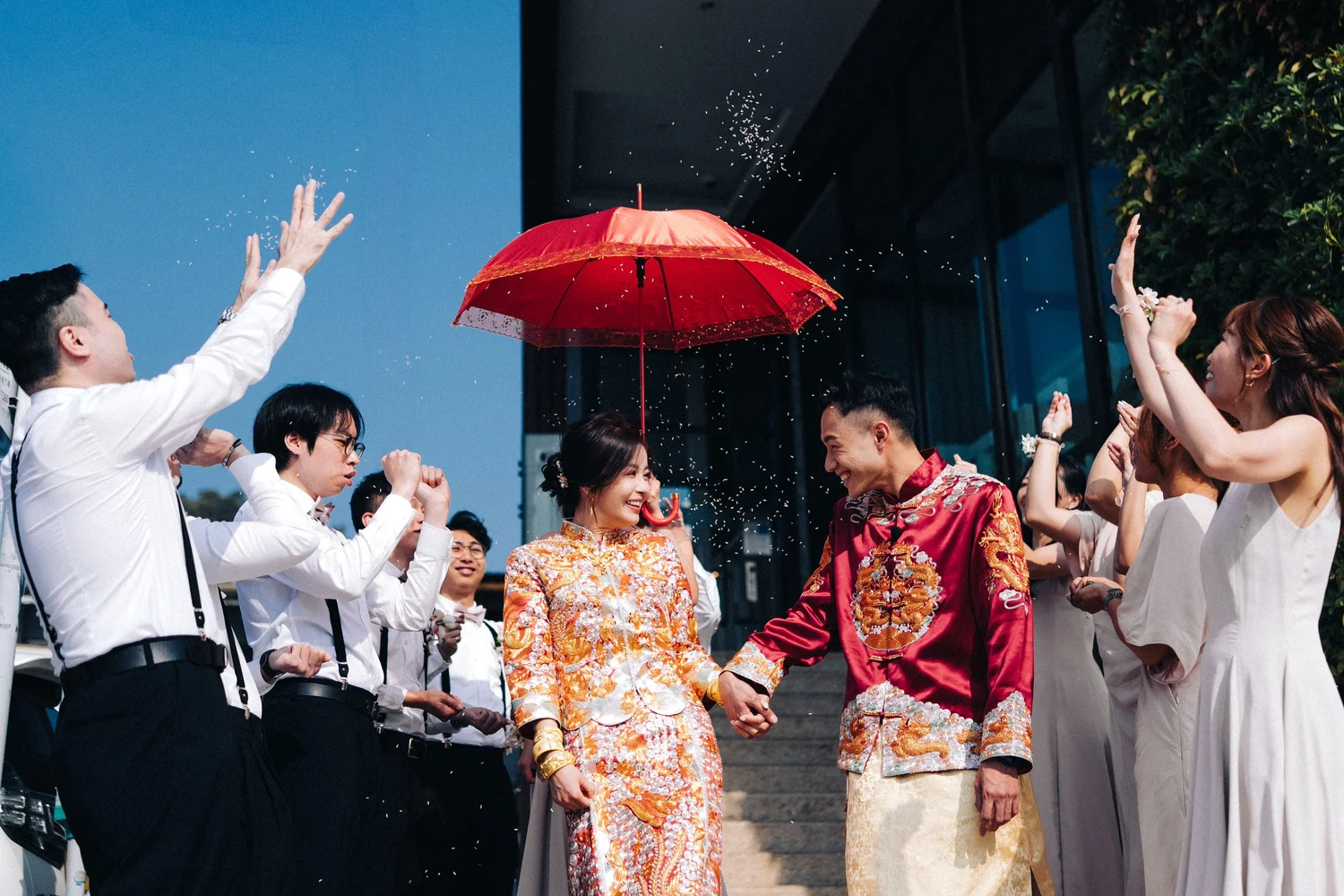 Charlie 與 Ernest 走出 The Pier Hotel,紅傘下灑落祝福