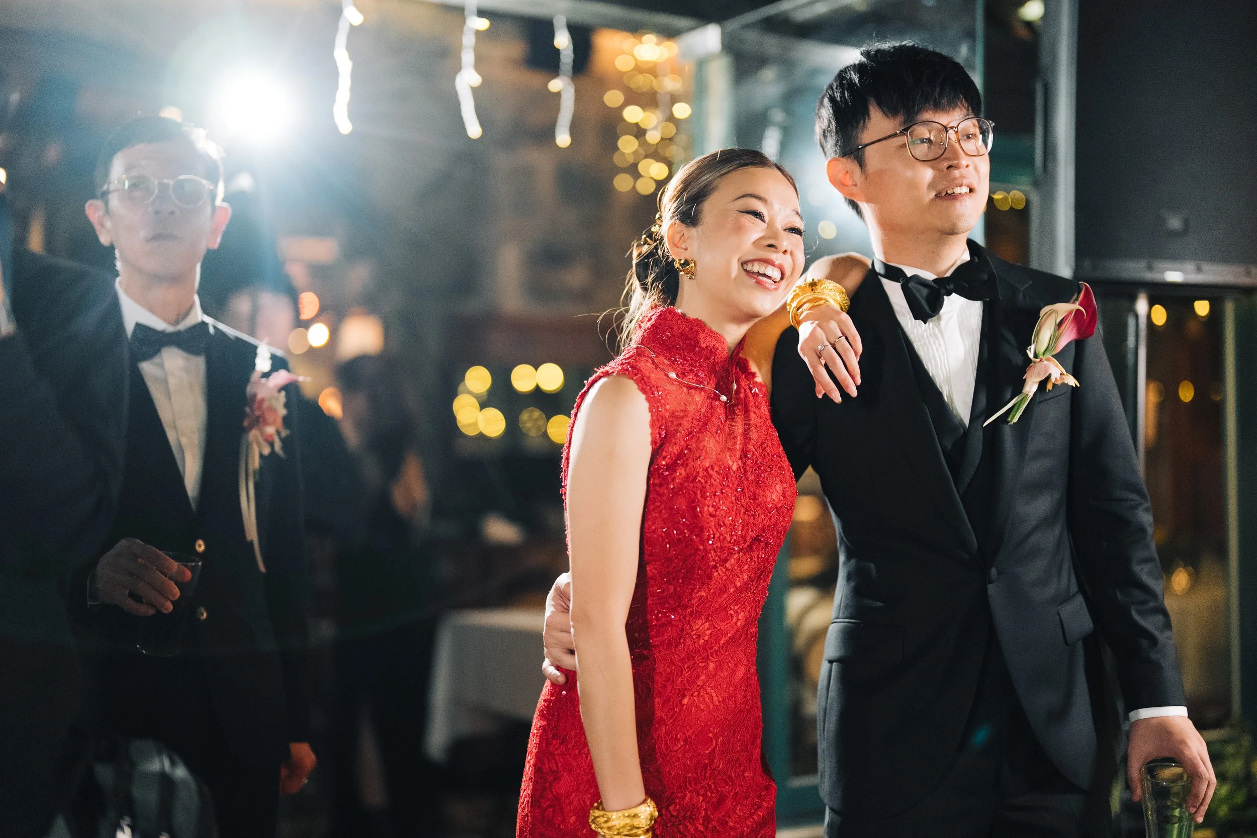 Phoebe and Jacky in red evening dress during their The Peak Lookout wedding reception in Hong Kong.