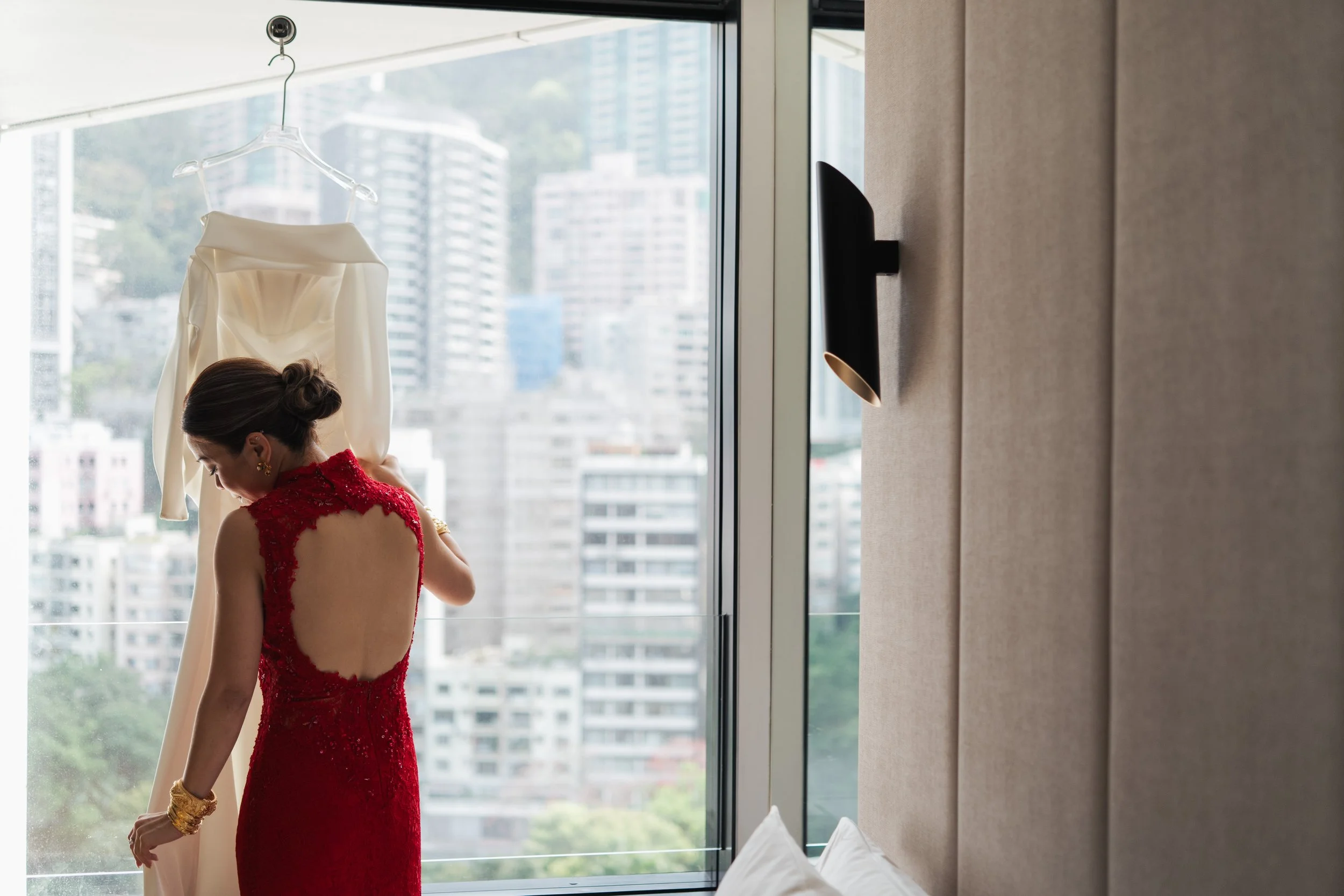 Phoebe in a red Chinese wedding dress beside her white bridal gown at The Murray Hong Kong.