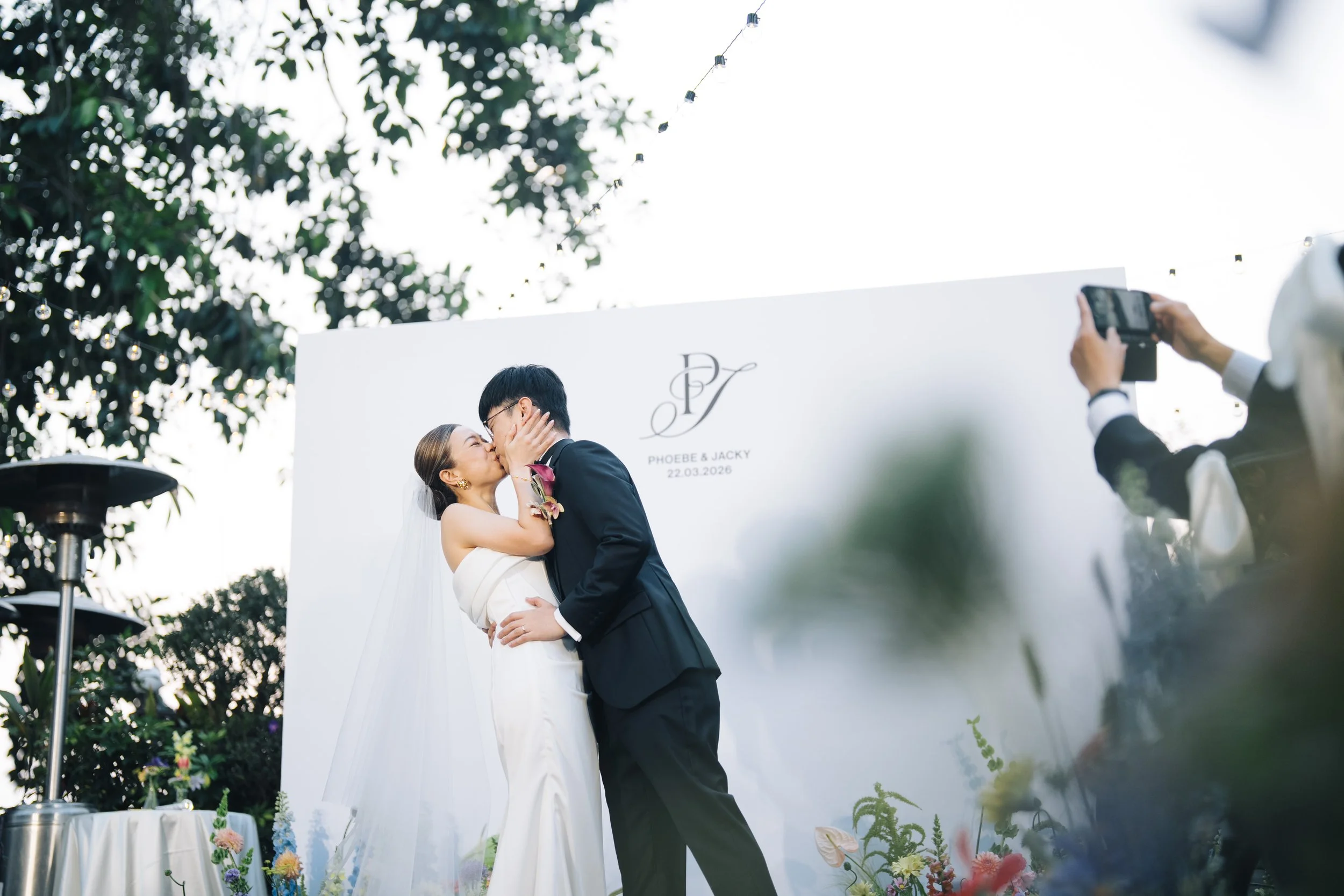 Phoebe and Jacky’s first kiss at their garden wedding ceremony at The Peak Lookout.