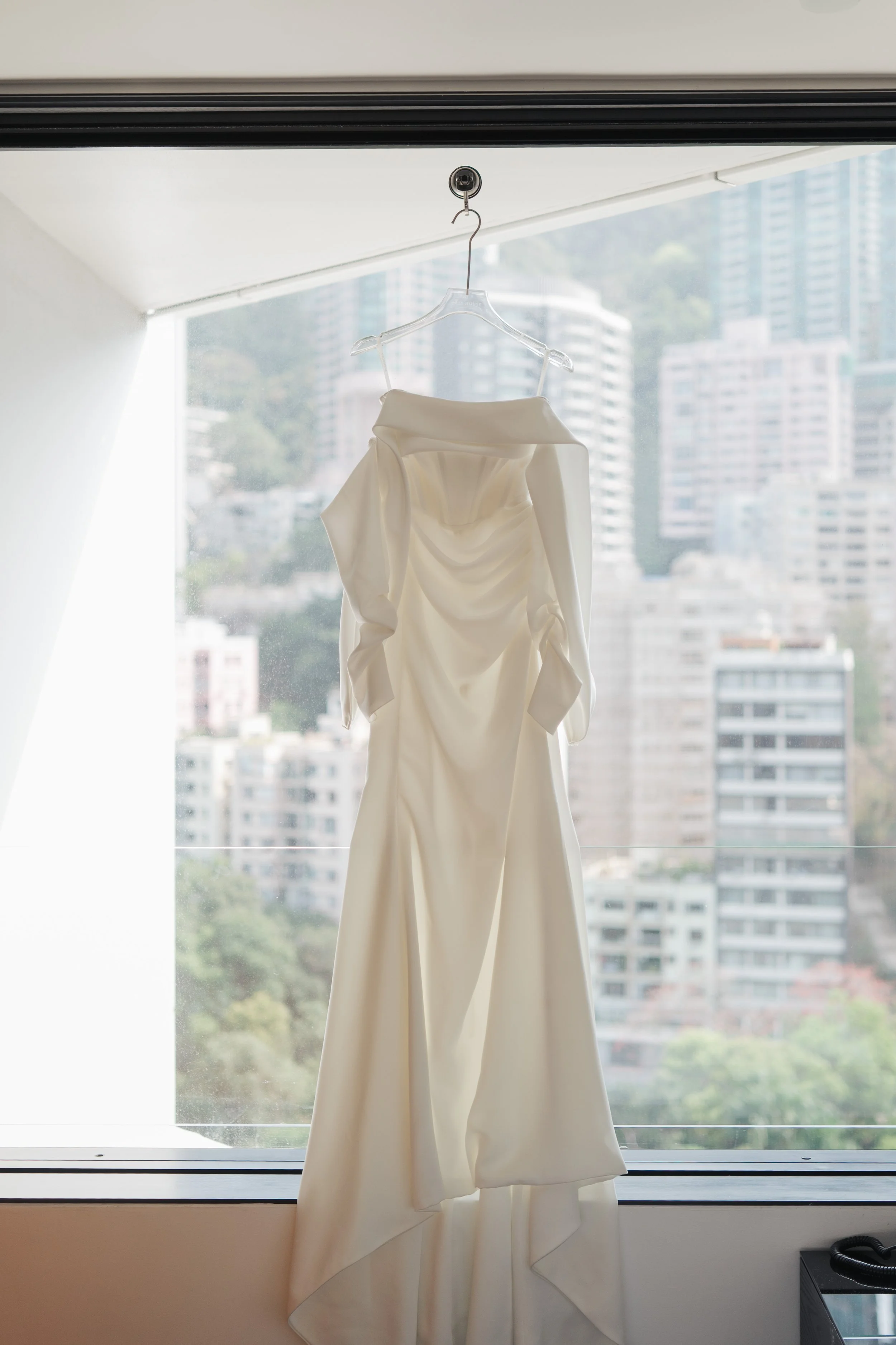 Phoebe’s white wedding gown by the window at The Murray Hong Kong, Admiralty, Hong Kong.