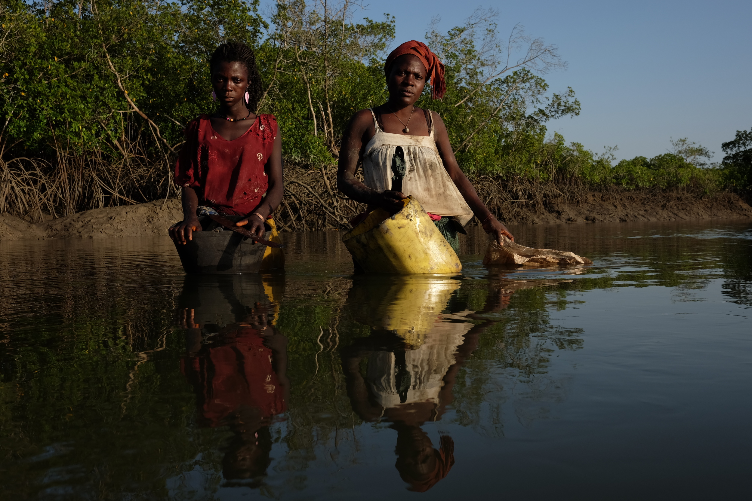   Ndra Lopes and Teresa Jaoquim pose while gathering&nbsp;  oysters  &nbsp;in the mangroves on Bubaque Island. Ndra, who is 22, goes to a local high school most afternoons after she either works in the rice fields or finishes gathering&nbsp;  oysters