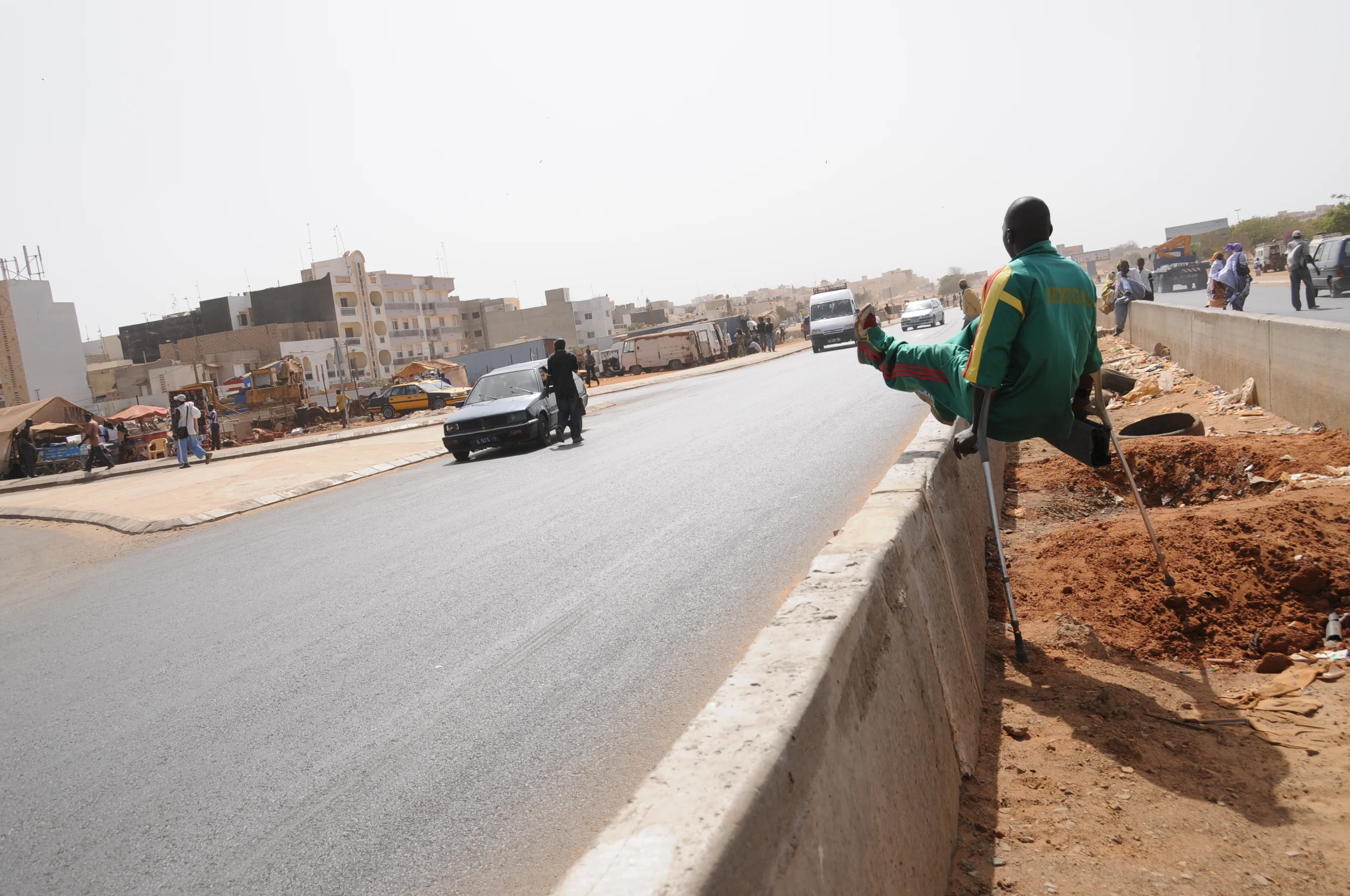  To get to practice every afternoon, Faye walks from work to catch a bus. He says the streets of Dakar are not handicapped friendly, and he has to jump over barriers such as the one on this busy highway in the country’s capital. 