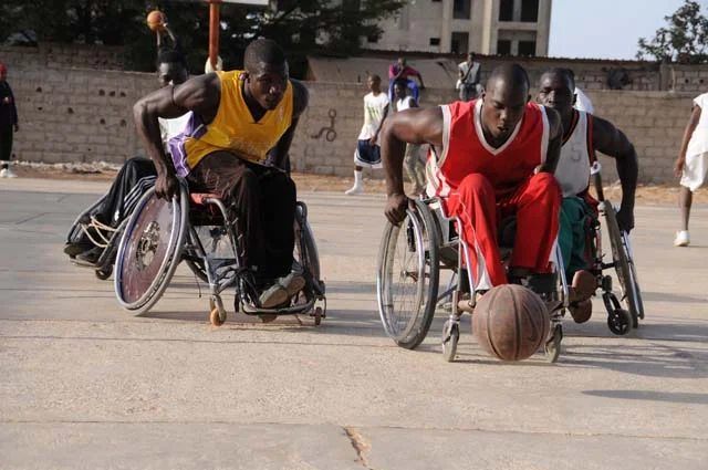  The teammates chase after a loose ball during the last practice before their first game of the tournament. The Talibou Dabo Center where they play is a meeting place for handicapped residents of Dakar. 
