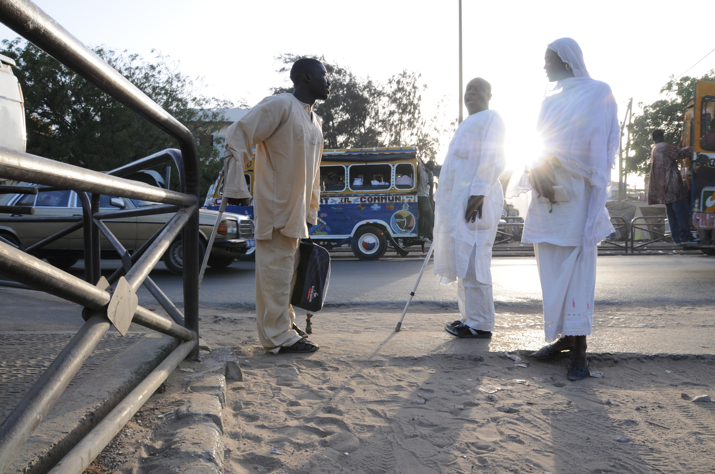  After practice, Faye makes it home as the sun sets. He says the handicapped community in Dakar is tight knit, and on the walk to his house he runs into another member of the Talibou Dabo Center and stops to chat. 