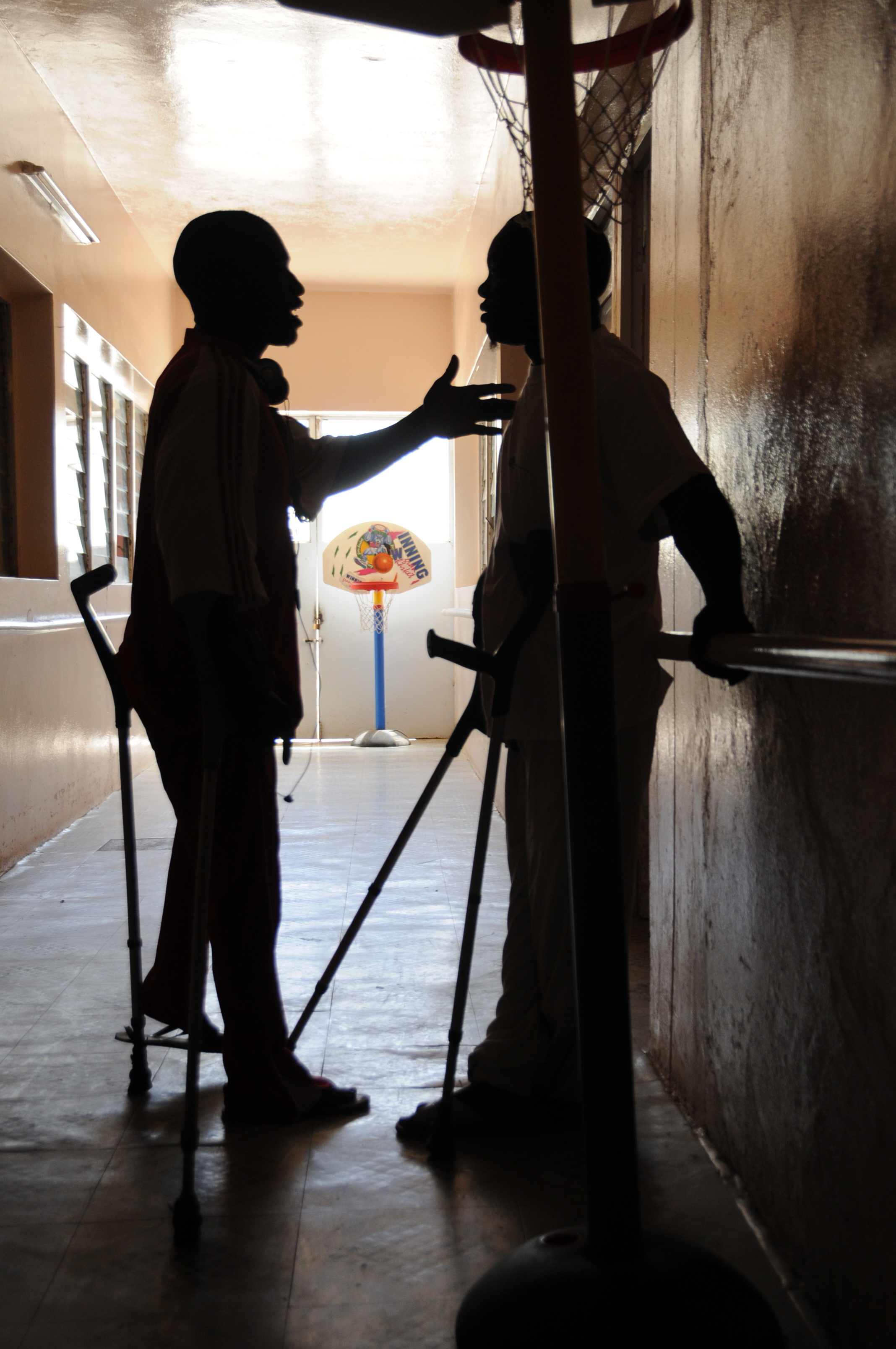  The bus hasn’t arrived to pick up the players yet, so the team captains take a minute to go to the hallway and discuss the day’s game. 