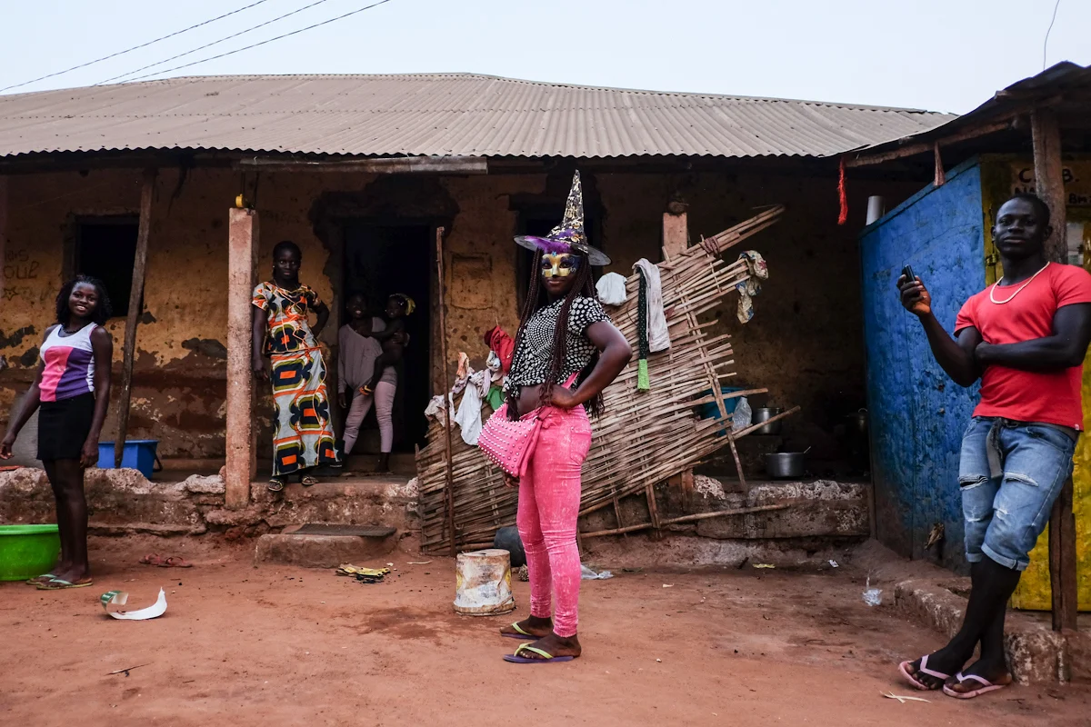 Bissau, Guinea Bissau (February 5, 2016) - A girl stops to pose in her witch hat and golden mask as Carnaval kicks off in Bissau. The theme of the festivities was celebrating Bissau tradition and culture. While participants competed to see which groups could outperform and outdress one another in traditional dances and clothing from various ethnic groups in Bissau, spectators outdid in each other in bright, modern fashion.