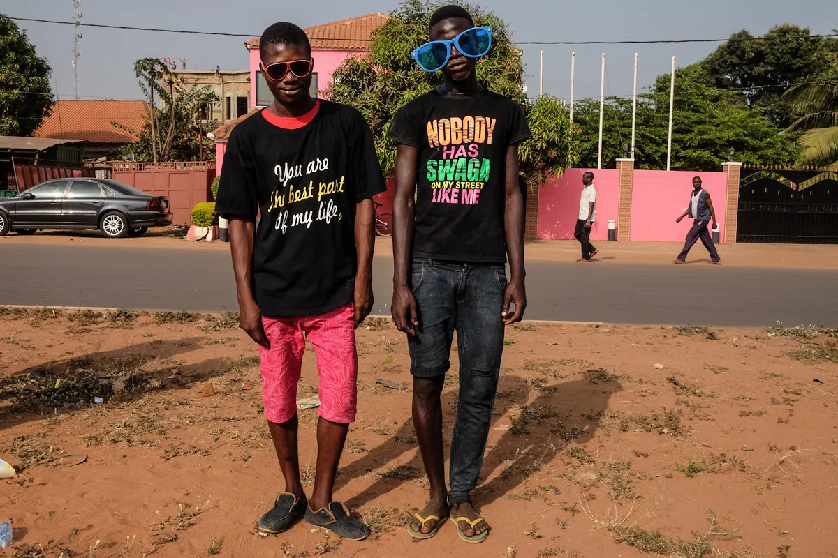 Bissau, Guinea-Bissau (February 6, 2016) - Carnaval spectators dressed in funky t-shirts and glasses take a pause to pose as they walk through the streets of Bissau.