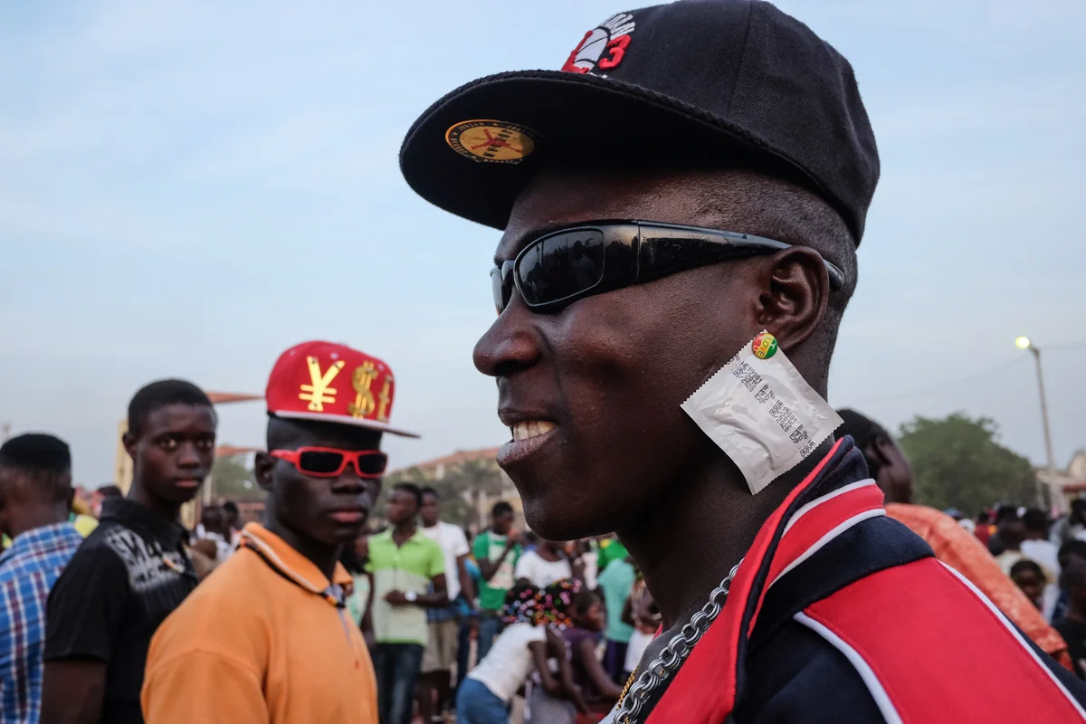 Bissau, Guinea-Bissau (February 7, 2016) - A man wears a condom as an earring, which says "I Love You," in Bissau during Carnaval.
