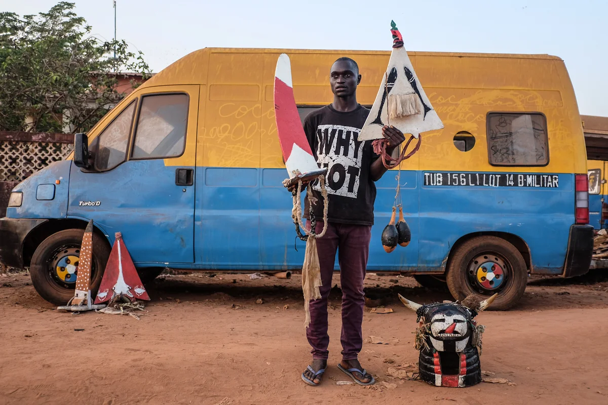 issau, Guinea-Bissau (February 9, 2016) - Sene, a member of the Bijagos island chain's group that performed during Bissau's Carnaval, poses with the costume he wore while dancing. The costum is worn traditionally during the coming-of-age ceremony, known as the Fanado.