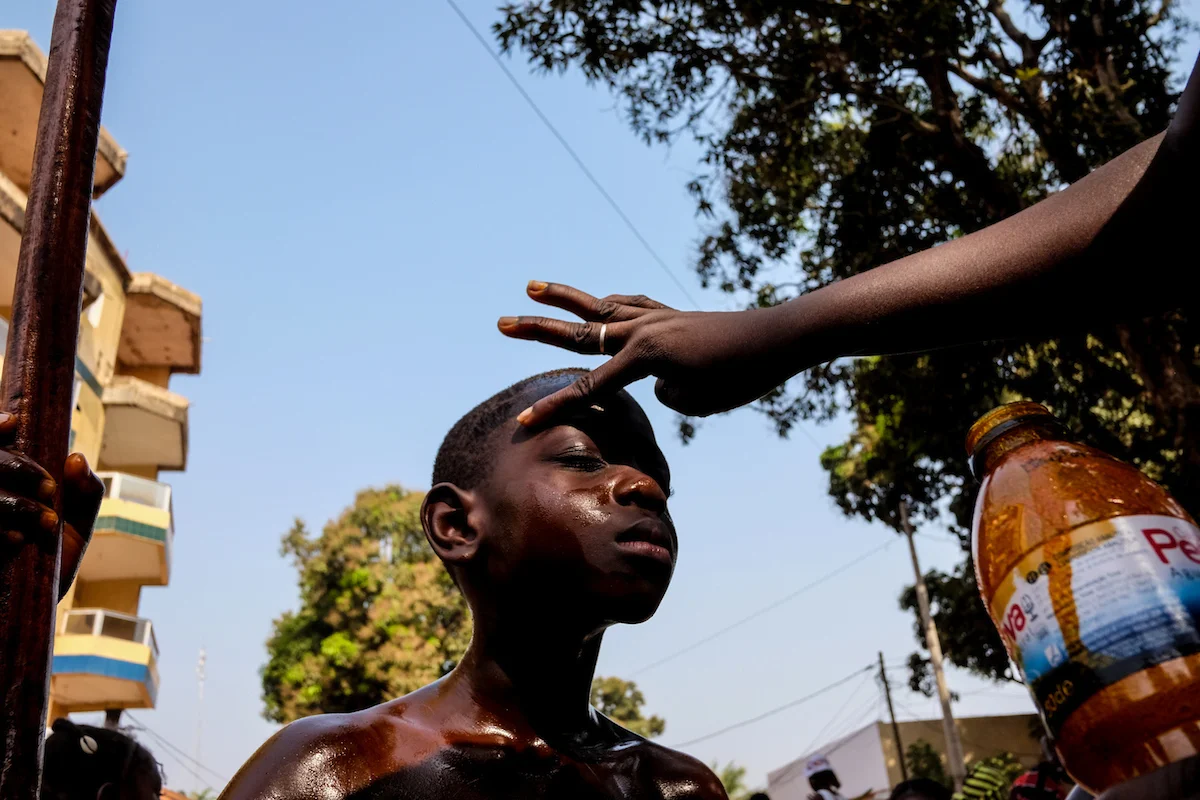 Bissau, Guinea-Bissau (February 5, 2016) - A boy, dressed in traditional clothing from the Bijagos ethnic group in Guinea Bissau - including palm oil spread all over his body - participates in Carnaval celebrations in Bissau, Guinea Bissau. The children were participating in events for Guinea Bissau's Carnaval. This year's Carnaval theme in the former Portuguese colony is "Rescue and Promote our Culture."