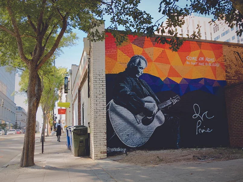 John Prine by Scott Nurkin was painted during the 2018 World of Bluegrass International Festival. This project is a collaboration between Oh Boy Records (John Prine’s label) and the Raleigh Murals Project (with help from Jeremy Clark). (Photo by Jeremy Clark)