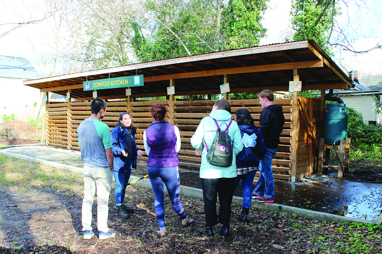 Kat Nigro, head of marketing and engagement at CompostNow, leads a group of UNC–Chapel Hill students on a tour of the Interfaith Food Shuttle garden, where compost is created and used onsite. (Photo: Arrin D. Widmayer)
