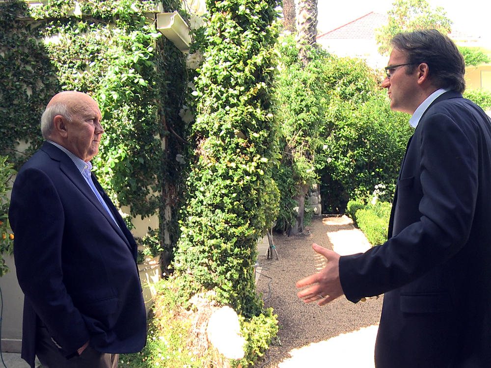 Director Nicolas Rossier talking to F.W. de Klerk at the former president's garden in Cape Town