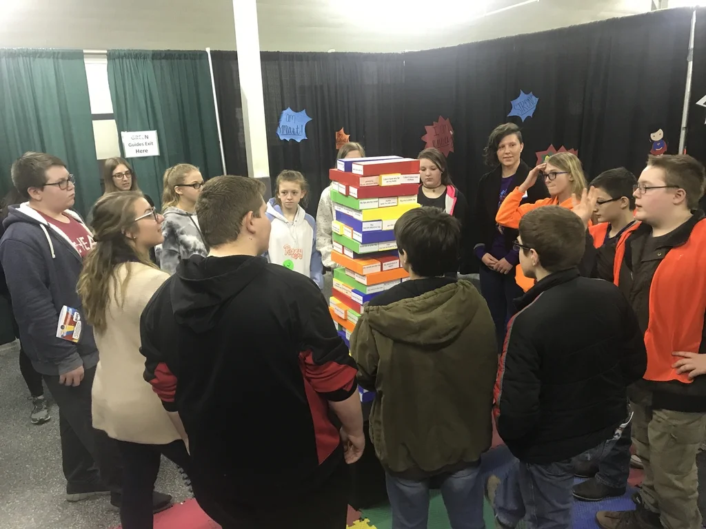 Jenna with youth at body image booth during Teen Maze event