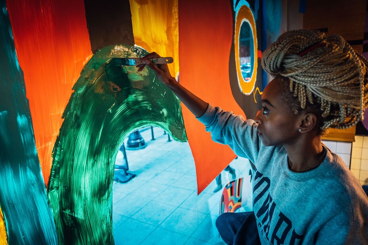  Brittany working on painting the mural. 